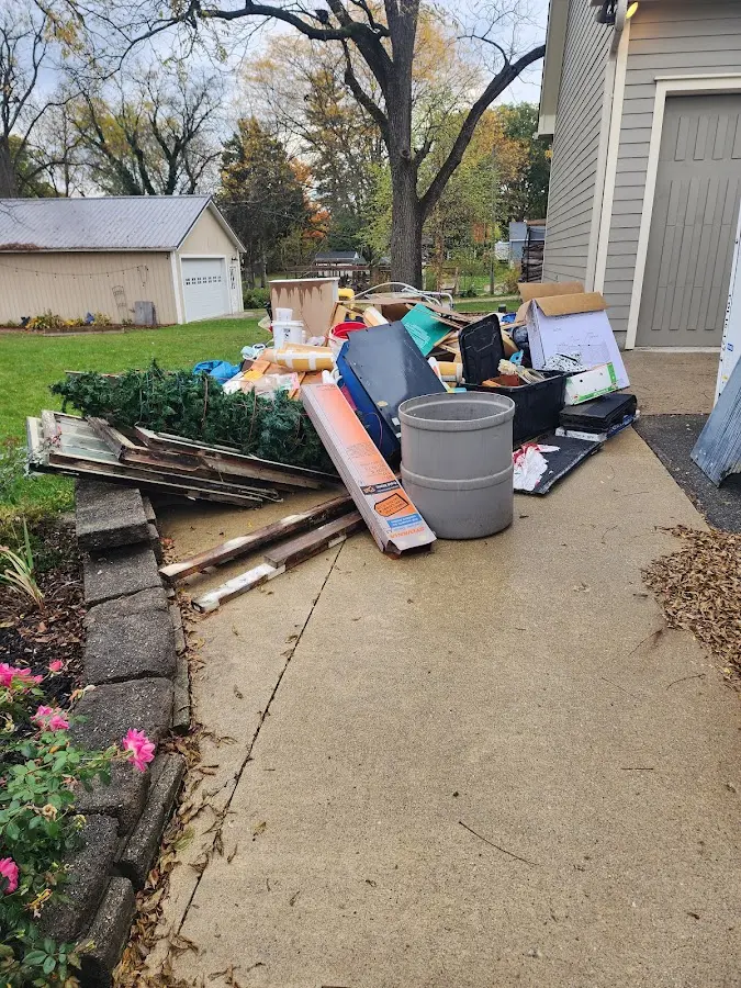 Dumpster being loaded with debris for 12 Yard Dumpster Rental in Montague